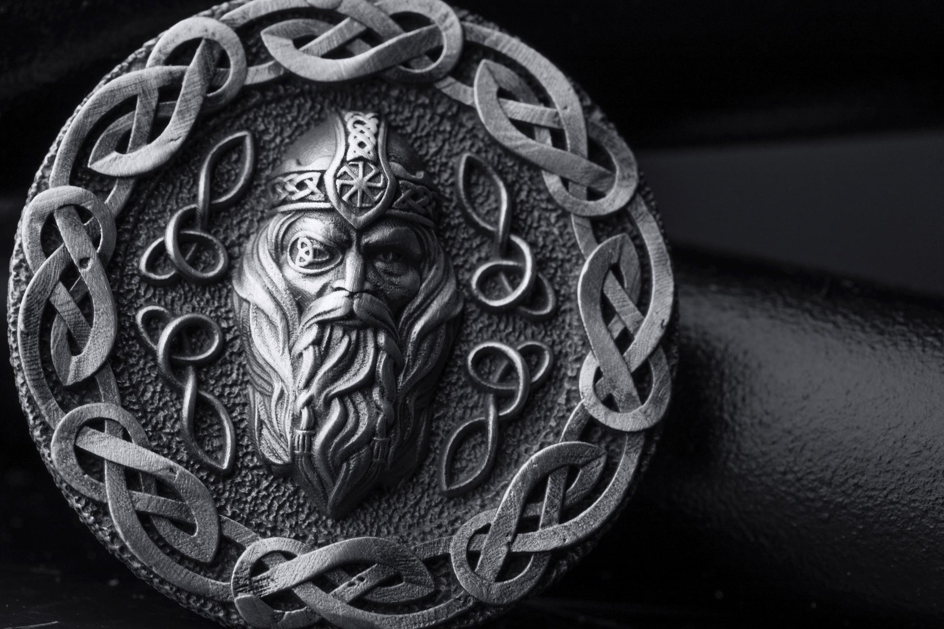 Silver Odin Pendant featuring a detailed depiction of Odin's face surrounded by intricate Celtic knotwork in a round silver design, showcasing expert craftsmanship and Norse mythology inspiration.