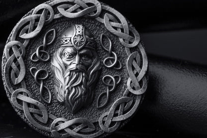 Silver Odin Pendant featuring a detailed depiction of Odin's face surrounded by intricate Celtic knotwork in a round silver design, showcasing expert craftsmanship and Norse mythology inspiration.