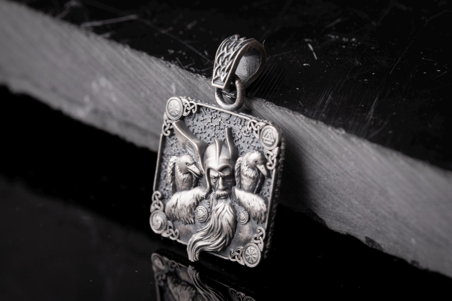 Intricately designed Scandinavian Viking Pendant featuring a detailed warrior face with a long beard, flanked by two ravens, crafted in silver with elaborate Nordic patterns.