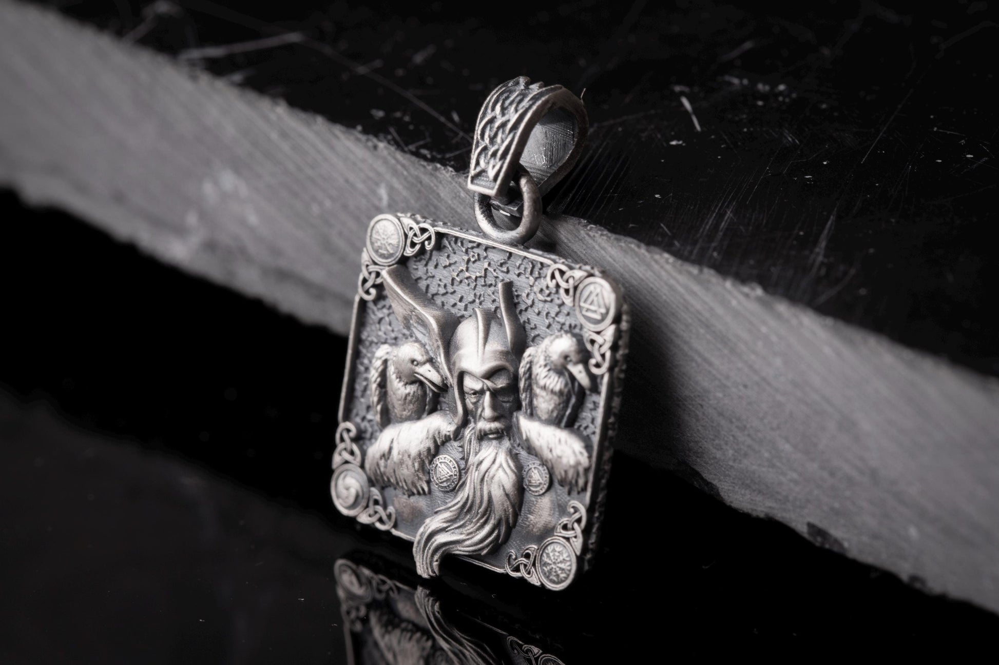 Intricately designed Scandinavian Viking Pendant featuring a detailed warrior face with a long beard, flanked by two ravens, crafted in silver with elaborate Nordic patterns.