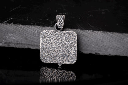 Silver textured square pendant with intricate woven detail on the bail, showcasing the Scandinavian Viking Pendant design in a rustic, polished finish.