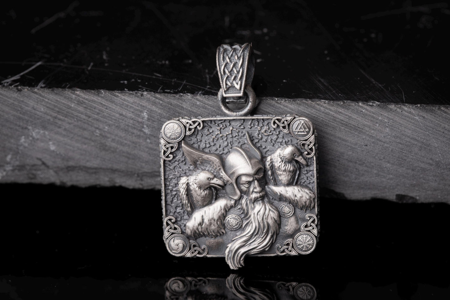 Intricately detailed Scandinavian Viking Pendant in silver featuring a Viking warrior’s face with a winged helmet and two birds, symbolizing strength and mythology.