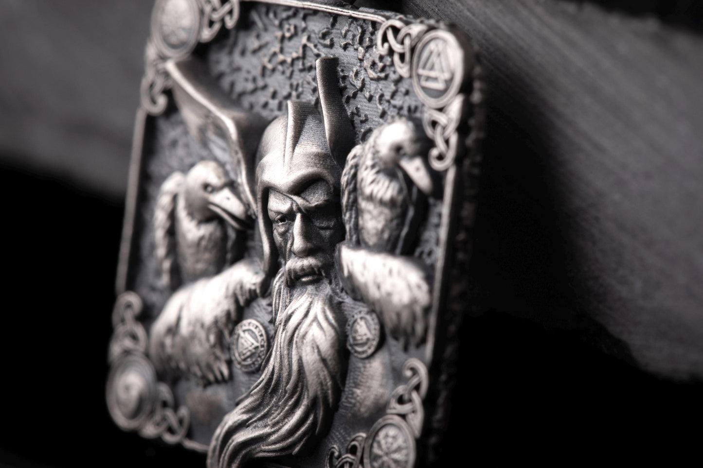 Close-up of a detailed silver Scandinavian Viking Pendant featuring a Viking warrior with a long beard and two ravens, showcasing intricate craftsmanship.