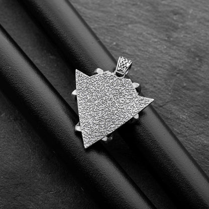 Sterling Silver Arrowhead Wolf Pendant featuring a textured arrowhead shape with intricate detailing, displayed on a black background highlighting its craftsmanship and silver finish.