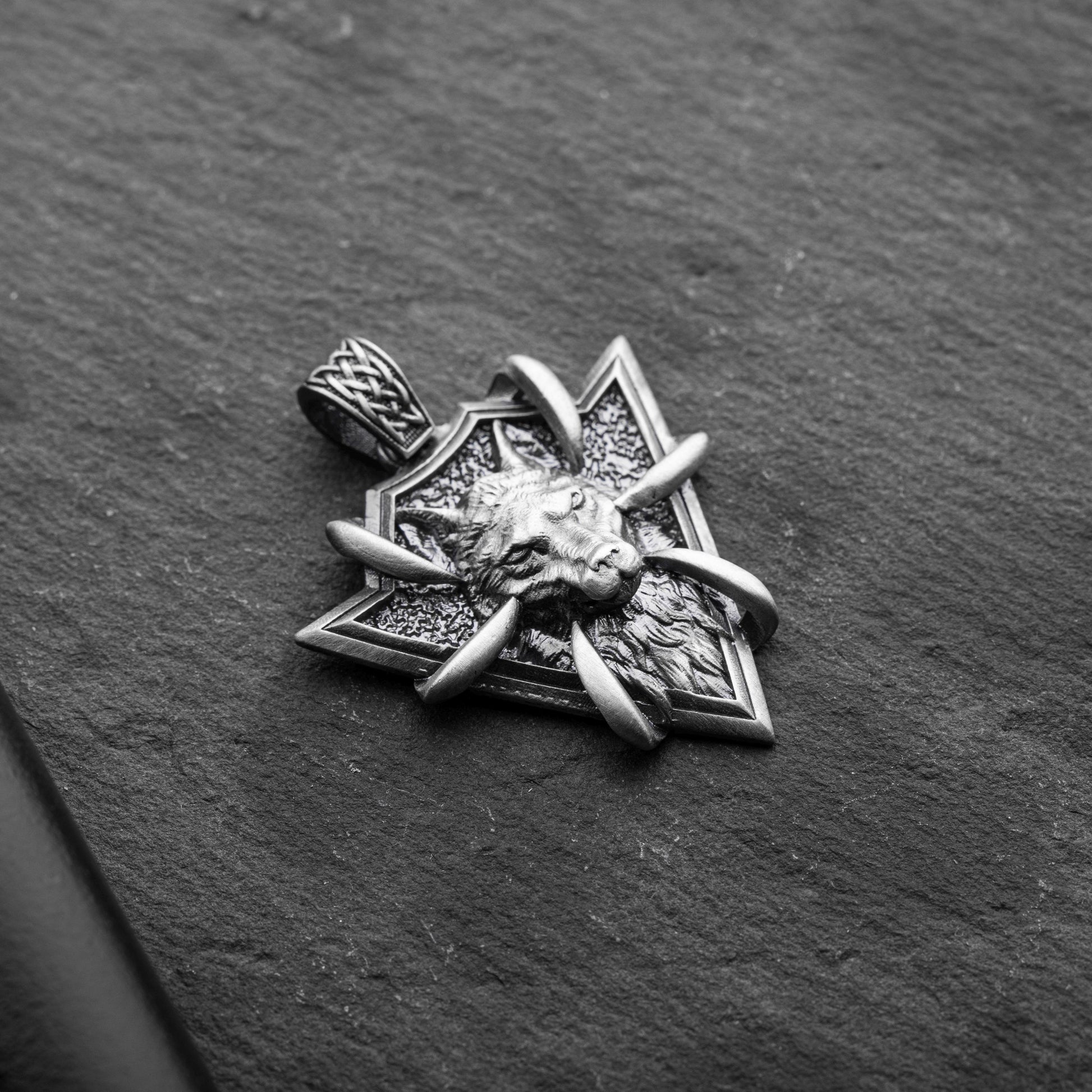 Sterling Silver Arrowhead Wolf Pendant featuring a detailed wolf head design with claw accents on a textured arrowhead background, crafted from silver jewelry.