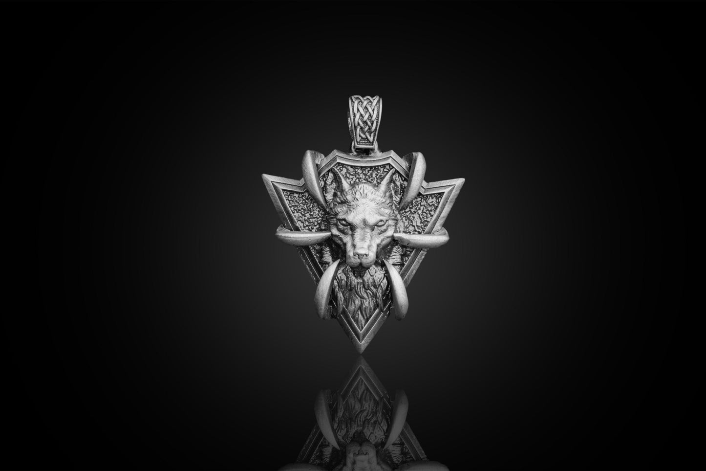 Sterling Silver Arrowhead Wolf Pendant featuring a detailed wolf head with tusks set in an intricately textured arrowhead design, perfect for silver jewellery collections.