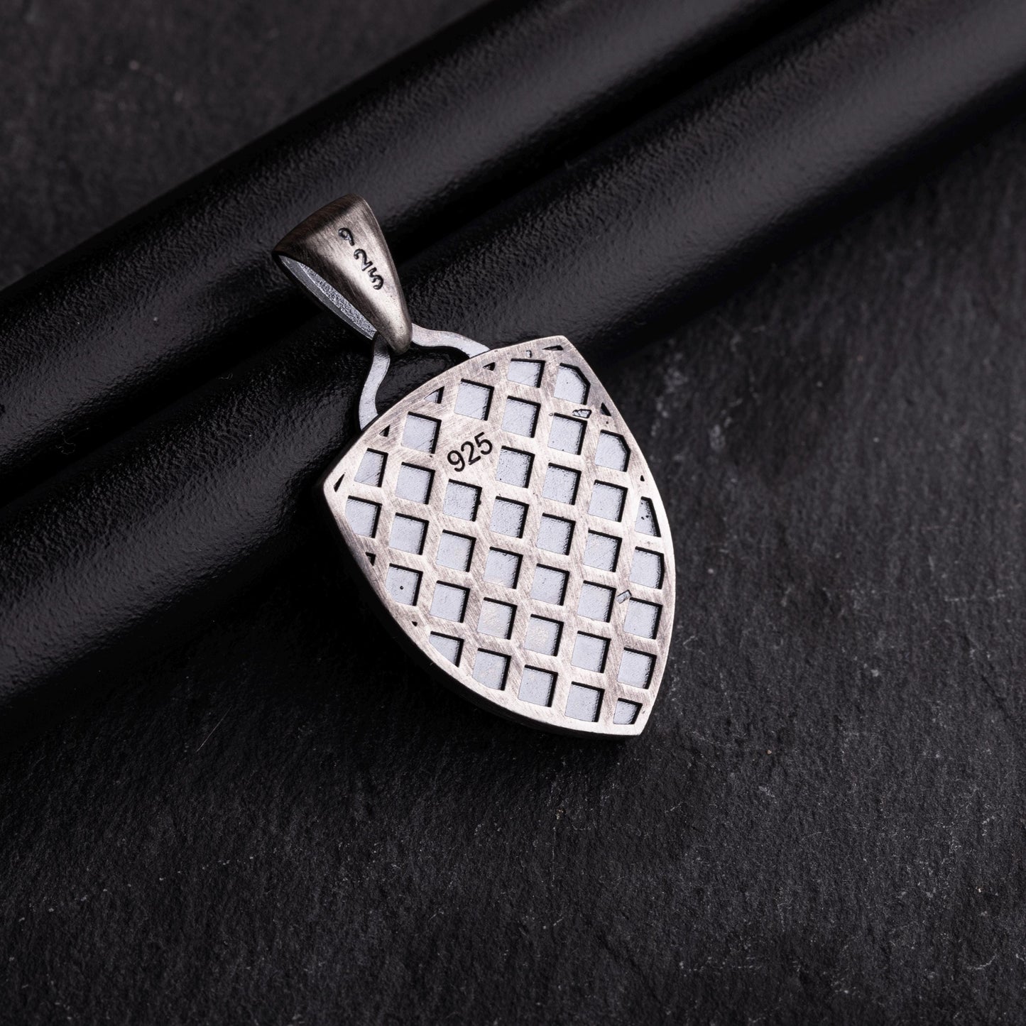 Back view of an Aries Ram Pendant crafted in 925 sterling silver with a geometric lattice pattern on a dark background.
