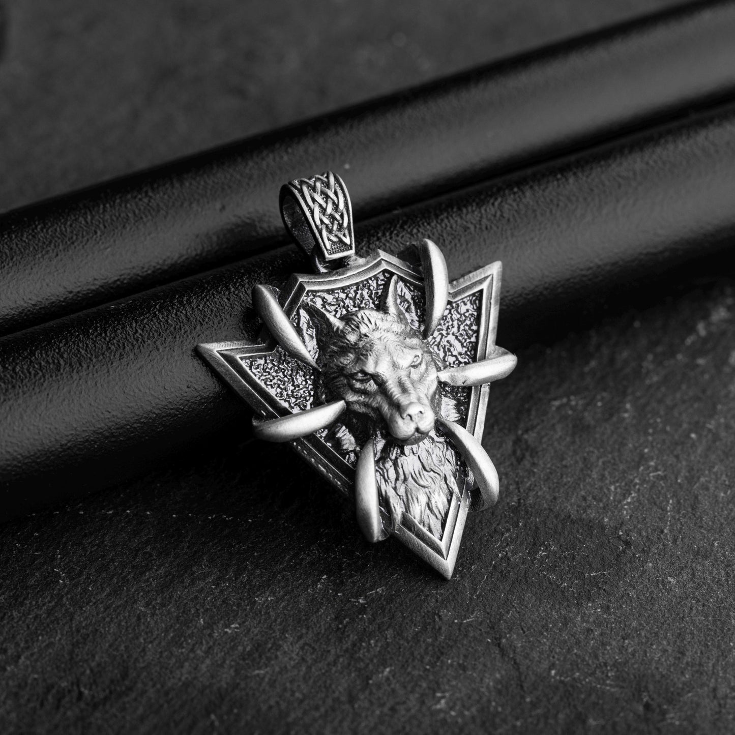 Sterling Silver Arrowhead Wolf Pendant featuring a detailed wolf head design with claw accents, crafted in textured silver for a bold and stylish look.