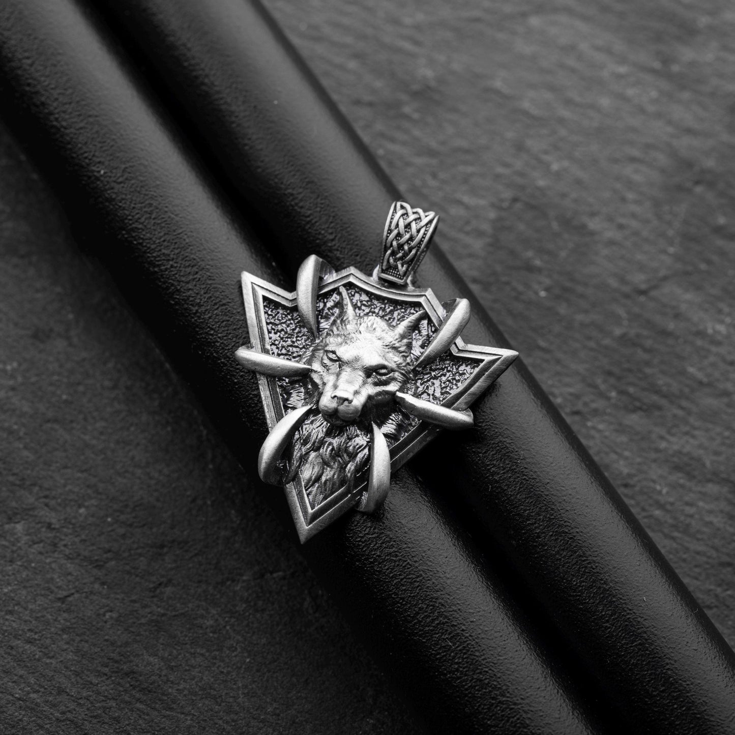 Sterling Silver Arrowhead Wolf Pendant featuring a detailed wolf head with claw accents on a textured arrowhead-shaped silver base, designed as a striking silver jewellery piece.