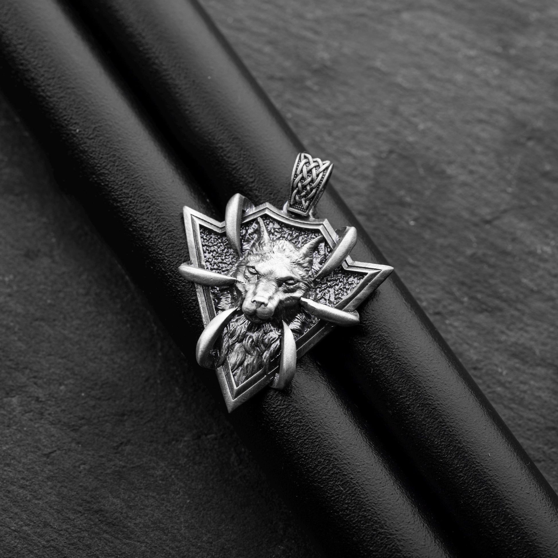 Sterling Silver Arrowhead Wolf Pendant featuring a detailed wolf head with claw accents on a textured arrowhead-shaped silver base, designed as a striking silver jewellery piece.