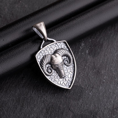 Aries Ram Pendant featuring a detailed ram head with curved horns on a textured shield-shaped silver background, designed as a stylish chain necklace accessory.