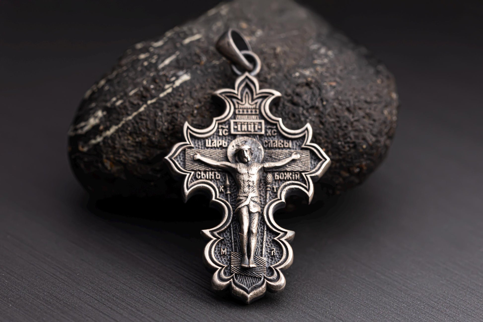 Jesus Crucifix Pendant crafted in detailed silver, featuring an ornate design with engraved religious inscriptions and a depiction of Jesus on the cross.