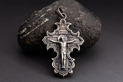 Jesus Crucifix Pendant crafted in detailed silver, featuring an ornate design with engraved religious inscriptions and a depiction of Jesus on the cross.