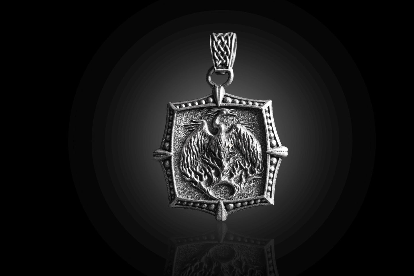 Silver Phoenix Pendant featuring detailed phoenix design in a textured silver setting with a woven silver bail, reflecting elegant craftsmanship in silver jewellery.